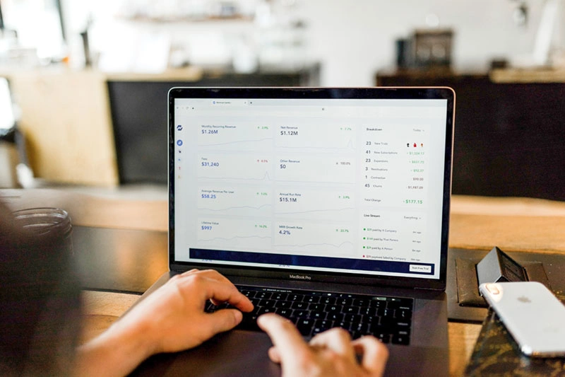 A person reviewing a retail dashboard on a laptop