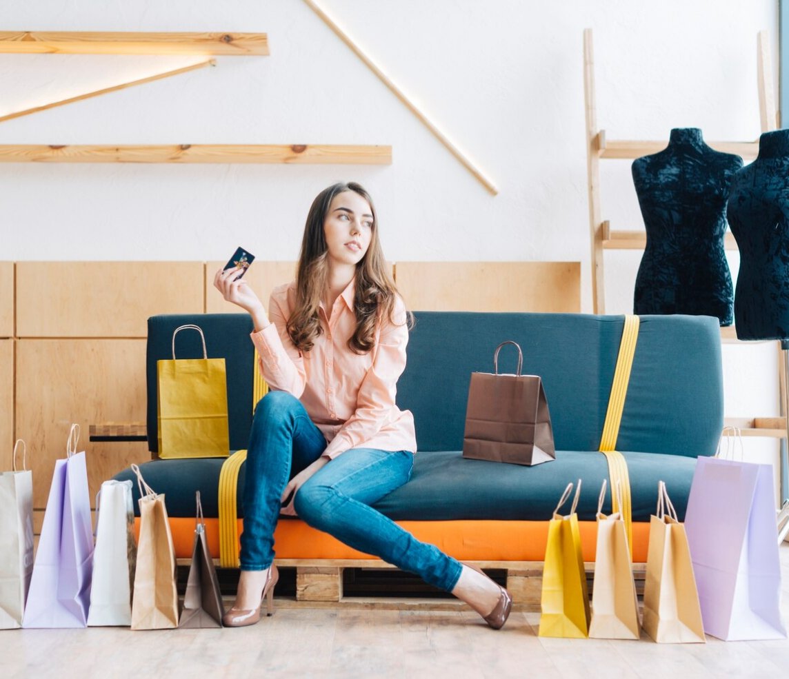 A customer choosing clothes from a rail in a fashion store
