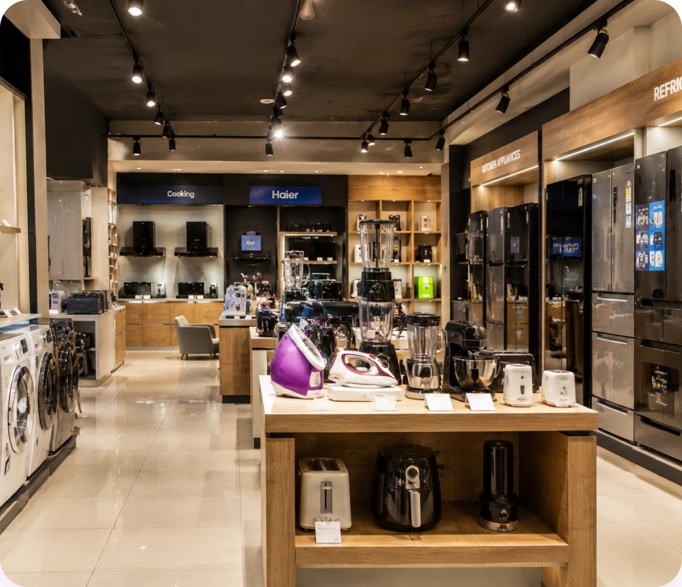 A consumer electronics showroom with kitchen appliances, refrigerators and washing machines on display